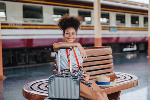 Tourists african american are showing happy expressions while waiting for their journey in the train station