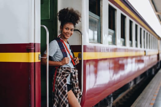 Tourists african american are showing happy expressions while waiting for their journey in the train station