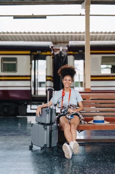 Tourists african american are showing happy expressions while waiting for their journey in the train station