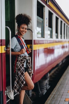 Tourists african american are showing happy expressions while waiting for their journey in the train station