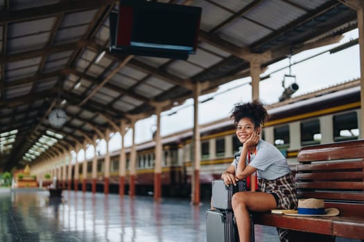 Tourists african american are showing happy expressions while waiting for their journey in the train station