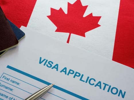 Visa application form and Canada flag.
