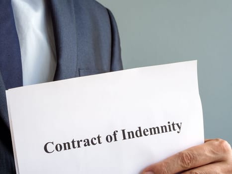 Man holds Contract of indemnity papers.