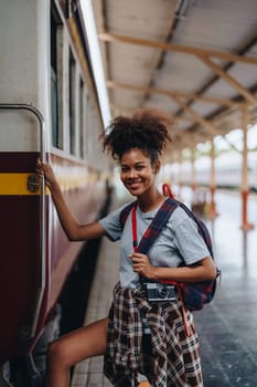 Tourists african american are showing happy expressions while waiting for their journey in the train station