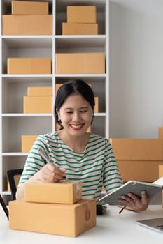 Businesswoman with Laptop and Parcel Box. A Symbol of SME Success in E-Commerce