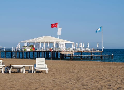 Luxury tent with sun beds on the pier, beach holidays in Turkey.