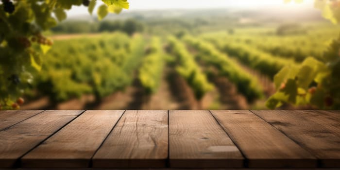 The empty wooden table top with blur background of vineyard. Exuberant image.