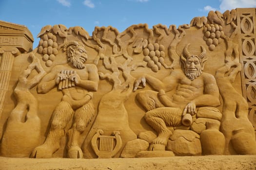 Sondervig, Denmark, May 21, 2023: International Sand Sculpture Festival. Satyrs