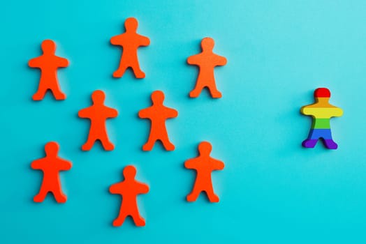 Diversity and Inclusion concept. A lot of red figurines and one colored figurine as symbol of diversity. Inclusive and discrimination concept.
