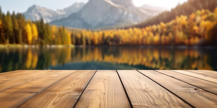 The empty wooden table top with blur background of lake and mountain in autumn. Exuberant image.