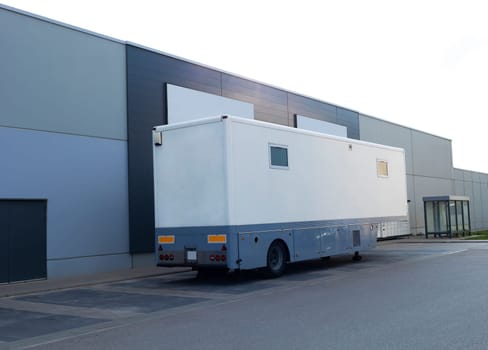 Lab On Wheels, Mobile Medical Center, Laboratory. White Truck, Bus On Parking Near Building. It Provide Blood Sampling, Health Testing, X-ray, Ultrasound. Mobile Outpatient Clinic. Horizontal Plane.