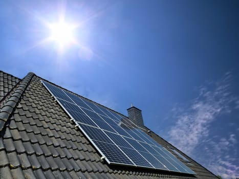 Solar panels producing clean energy on a roof of a residential house