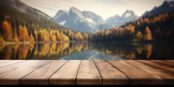 The empty wooden table top with blur background of lake and mountain in autumn. Exuberant image.