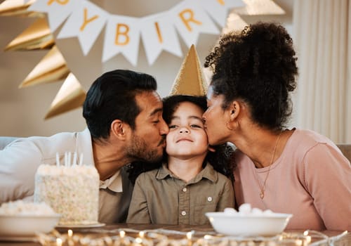 Father, mother and child at birthday party, kiss and happy with celebration, care and bonding in family house. Dad, mom and young kid with event, excited face and love together at table in apartment.