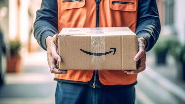 Faceless delivery man holding Amazon prime cardbox parcel box looking at camera blurred street background. Generative ai
