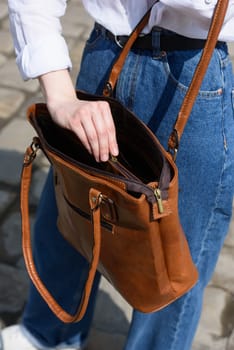 small brown women's leather bag. street photo