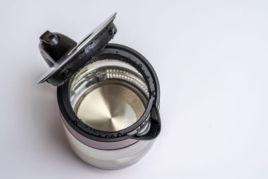 glass electric kettle with an open lid on a white background top view.