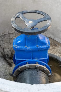 A valve or valve in a valve concrete well of an underground sewer. Construction of pipeline networks. Laying of the pipeline of the water supply system in the city. Water supply, repair of worn-out pipelines.