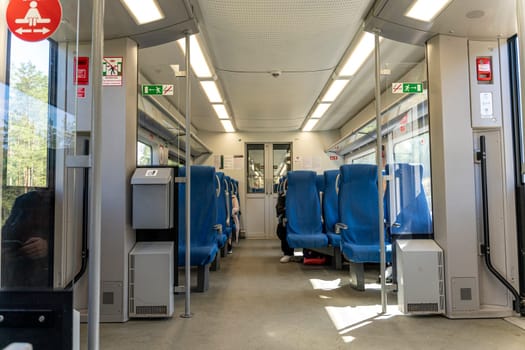a commuter train car. A fun trip. Get around by public transport. Holidays, a trip to school. traveling by train. Interior of railway transport. a train car with seats and windows