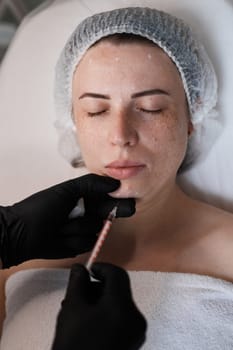 woman receives cosmetic botox injection in face. Woman in beauty salon. plastic surgery.