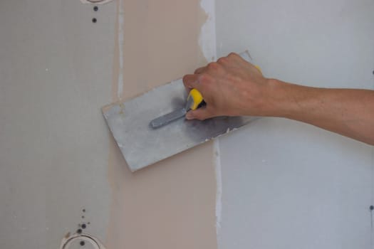 the master plasters the walls and ceiling. Selective focus