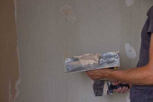 the master plasters the walls and ceiling. Selective focus