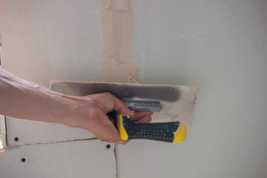 the master plasters the walls and ceiling. Selective focus
