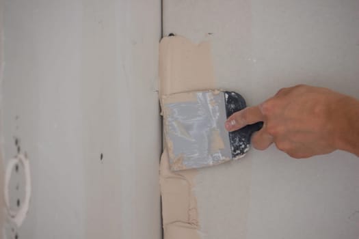 the master plasters the walls and ceiling. Selective focus