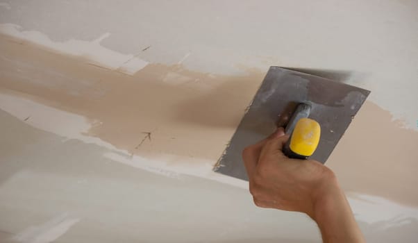 the master plasters the walls and ceiling. Selective focus