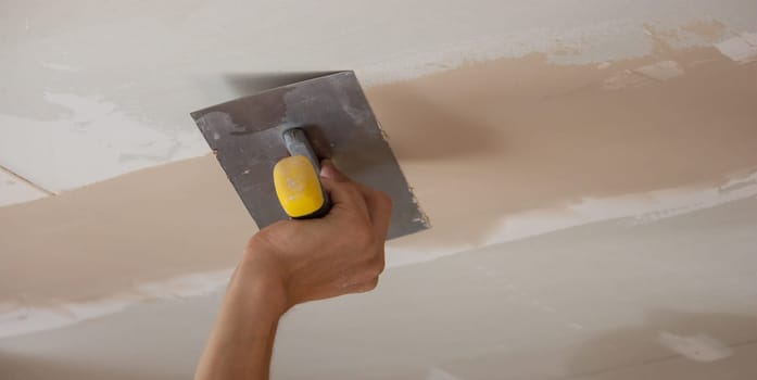 the master plasters the walls and ceiling. Selective focus