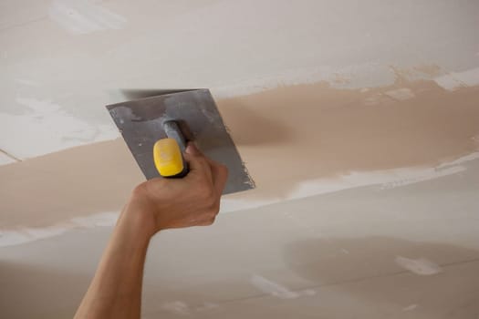 the master plasters the walls and ceiling. Selective focus