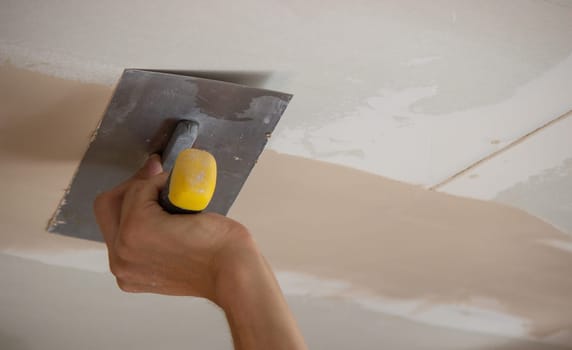 the master plasters the walls and ceiling. Selective focus