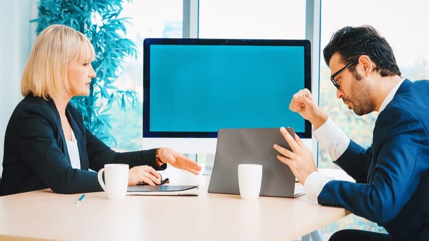 Business people in the conference room with green screen chroma key TV or computer on the office table. Diverse group of businessman and businesswoman in meeting on video conference call . Jivy