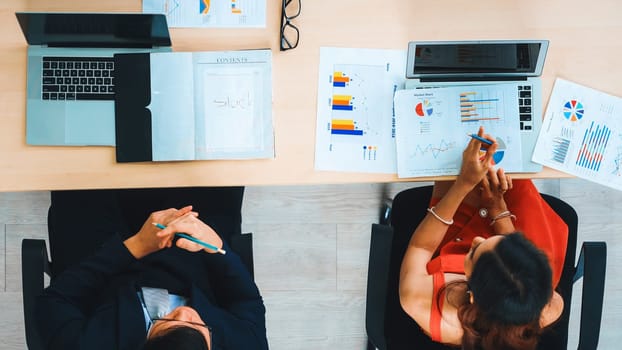 Business people group meeting shot from top view in office . Profession businesswomen, businessmen and office workers working in team conference with project planning document on meeting table . Jivy