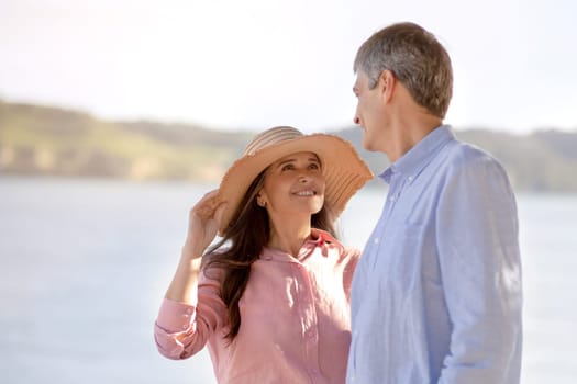 Romantic Mature Spouses Having Walk Near Sea In Summer Time, Loving Middle Aged Couple Relaxing Outdoors And Bonding With Each Other, Wife Looking At Husband With Love, Wearing Straw Hat