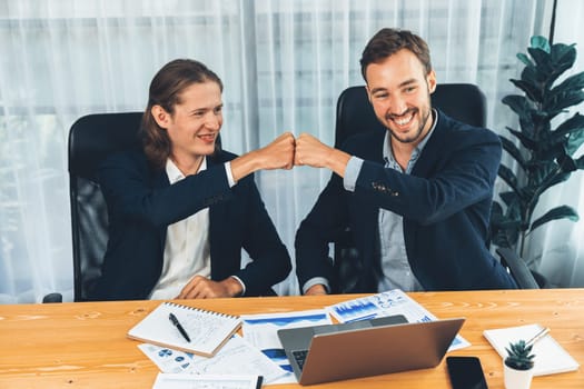 Businessmen celebrate success with joyous expressions, celebratory fist gesture in office after analyzing data or achieving target. Teamwork and planning lead to successful outcome. Entity