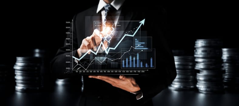 Businessman analyst working with digital finance business data graph showing technology of investment strategy for perceptive financial business decision. Digital economic analysis technology concept.