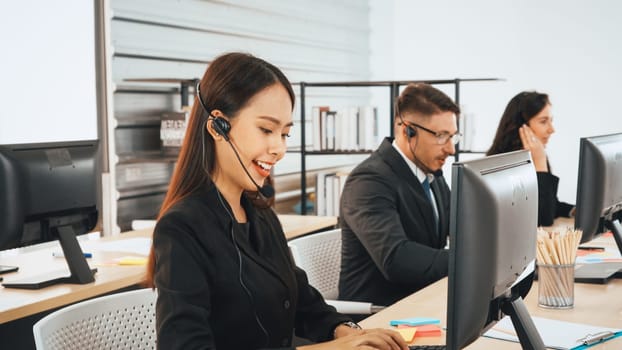 Business people wearing headset working in office to support remote customer or colleague. Call center, telemarketing, customer support agent provide service on telephone video conference call. Jivy