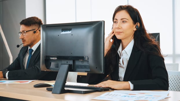 Business people wearing headset working in office to support remote customer or colleague. Call center, telemarketing, customer support agent provide service on telephone video conference call. Jivy