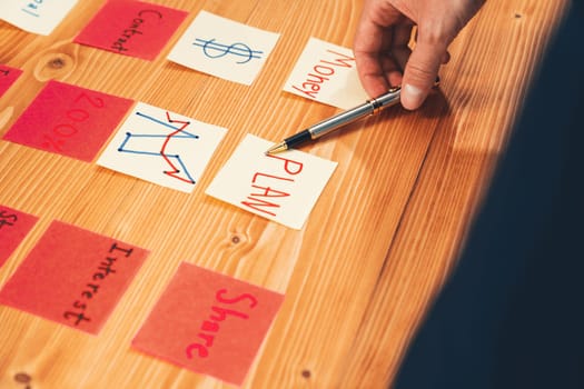 Business team gather on table, brainstorming and writing creative idea on colorful post-it notes. Planning and brainstorm strategy to achieve business targets. fervent