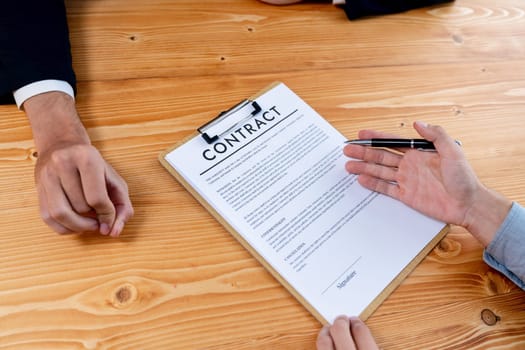 Executives sign contract in meeting room. Business people seal deal on paper. Successful agreement between two business partnership with signature signed on legal document. Jubilant