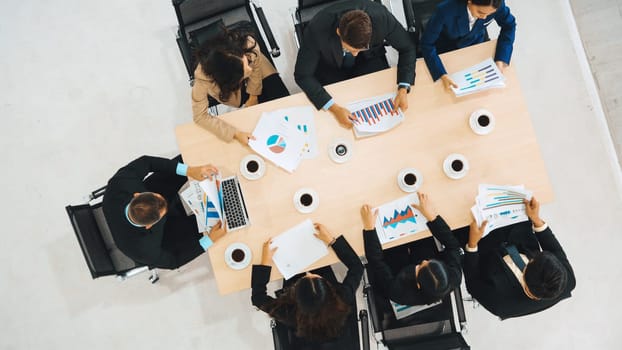 Business people group meeting shot from top view in office . Profession businesswomen, businessmen and office workers working in team conference with project planning document on meeting table . Jivy