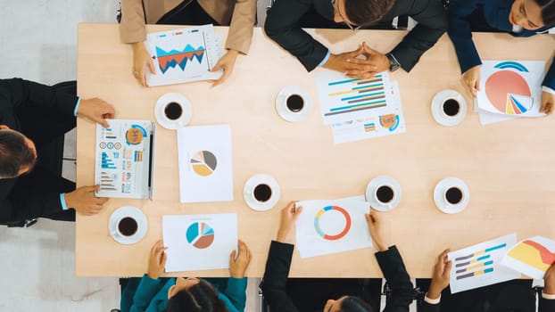 Business people group meeting shot from top view in office . Profession businesswomen, businessmen and office workers working in team conference with project planning document on meeting table . Jivy