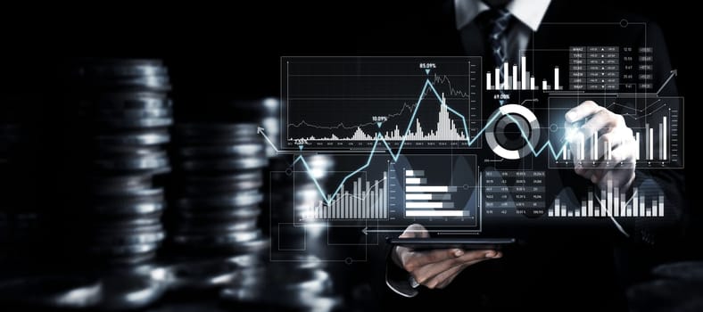 Businessman analyst working with digital finance business data graph showing technology of investment strategy for perceptive financial business decision. Digital economic analysis technology concept.