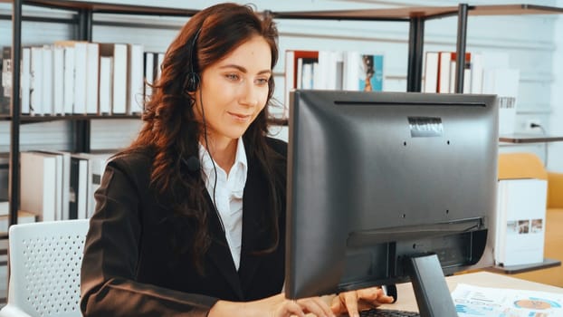 Business people wearing headset working in office to support remote customer or colleague. Call center, telemarketing, customer support agent provide service on telephone video conference call. Jivy