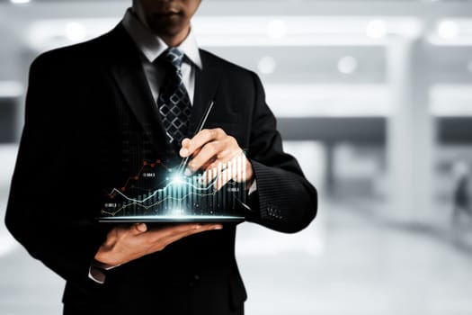 Businessman analyst working with digital finance business data graph showing technology of investment strategy for perceptive financial business decision. Digital economic analysis technology concept.