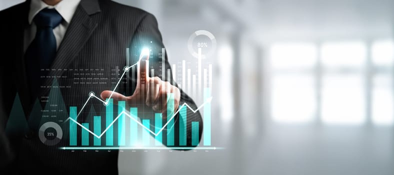 Businessman analyst working with digital finance business data graph showing technology of investment strategy for perceptive financial business decision. Digital economic analysis technology concept.