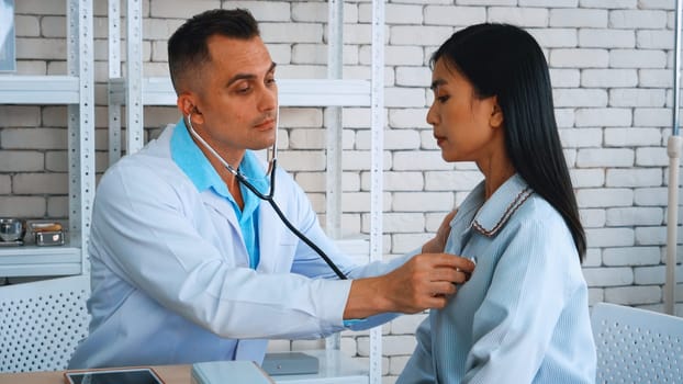 Doctor in professional uniform examining patient at hospital or medical clinic. Health care , medical and doctor staff service concept. Jivy