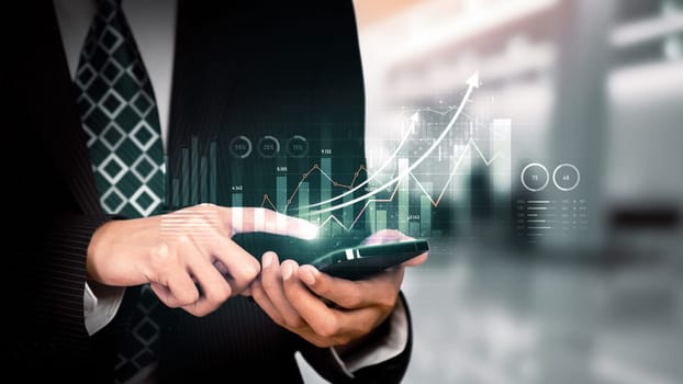Businessman analyst working with digital finance business data graph showing technology of investment strategy for perceptive financial business decision. Digital economic analysis technology concept.
