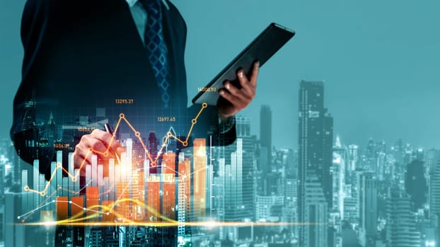 Businessman analyst working with digital finance business data graph showing technology of investment strategy for perceptive financial business decision. Digital economic analysis technology concept.